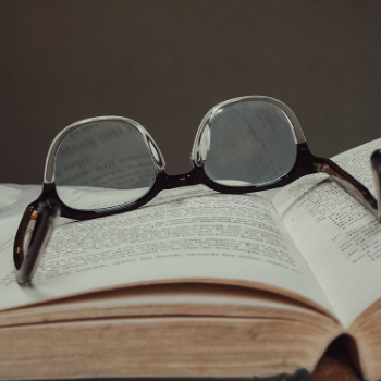 Glasses on open book